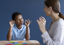 Mental health professional communicating with a child with the help of an interpreter.