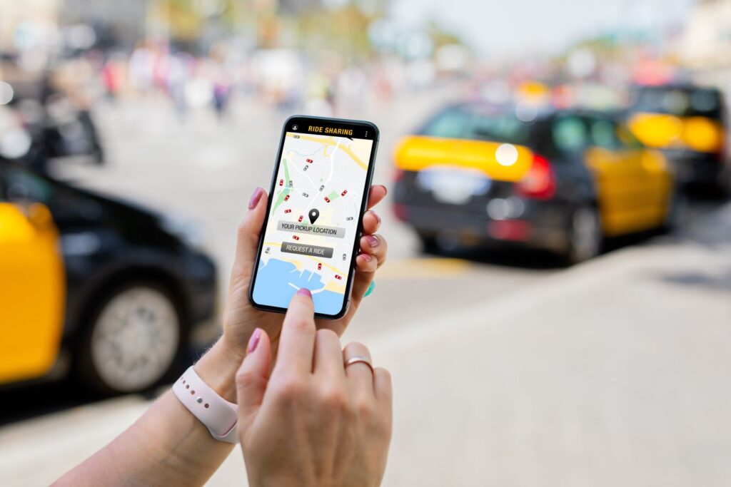 Person holding phone using a ride sharing app