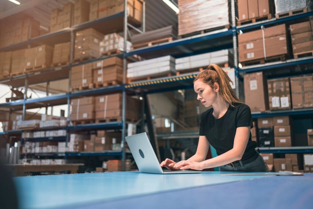 Young woman working in an e-commerce and shipment facility.