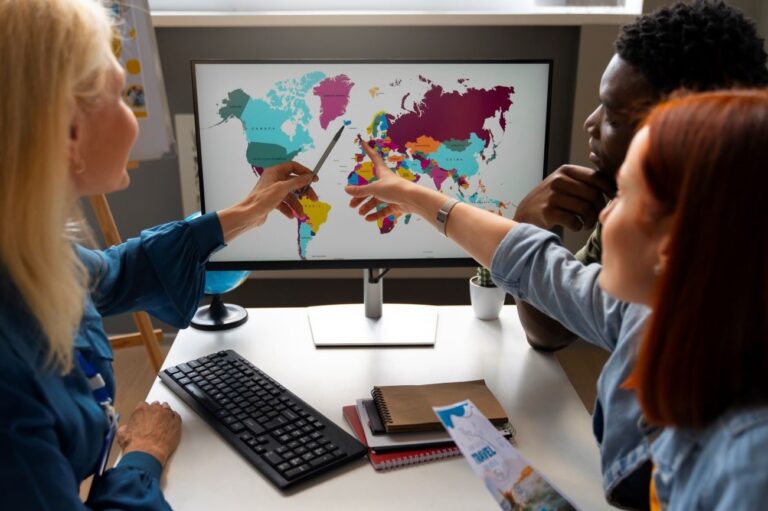 Woman working as a travel agent pointing at a world map.