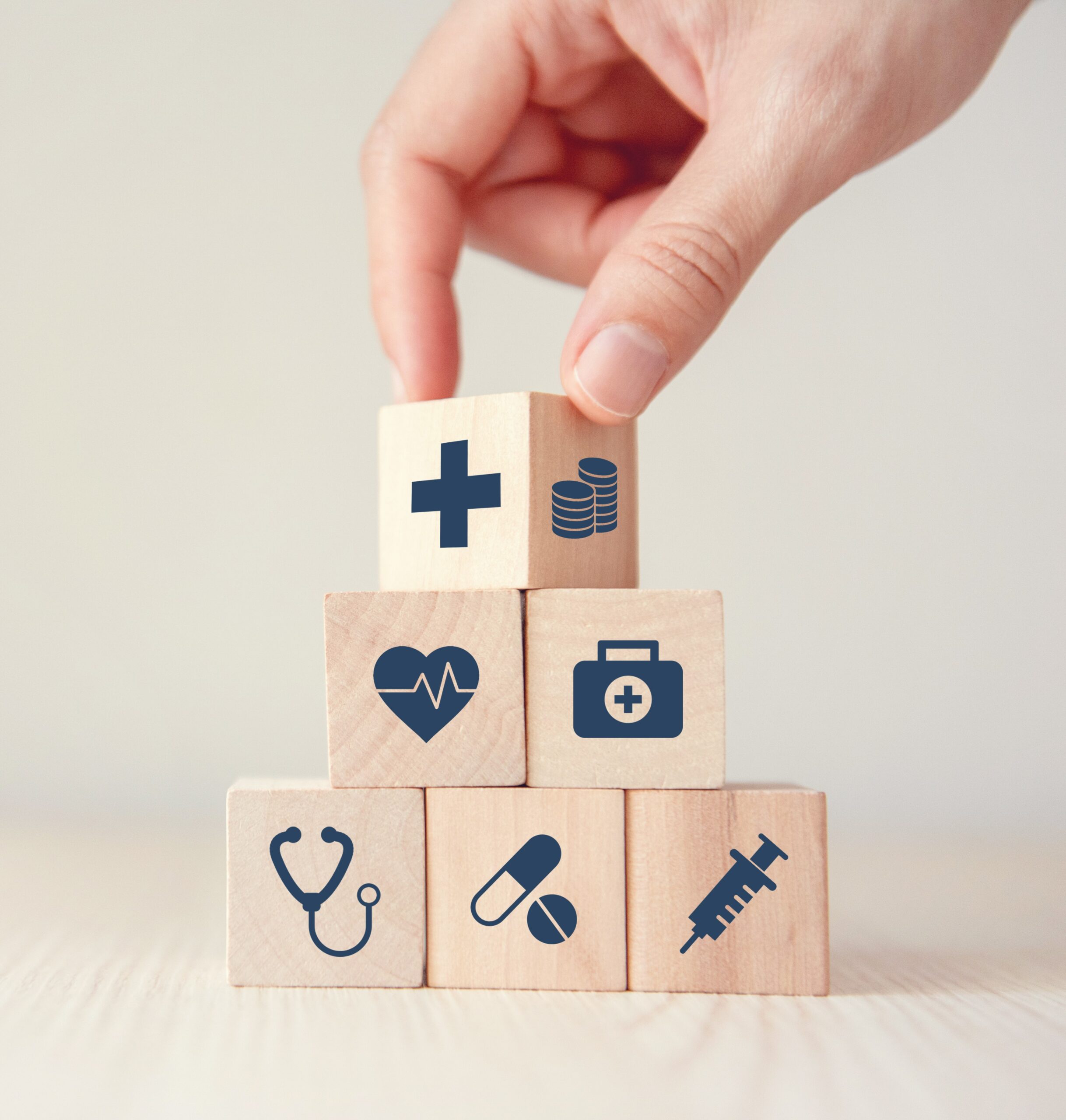 Wooden cubes with medical illustrations for health insurance.